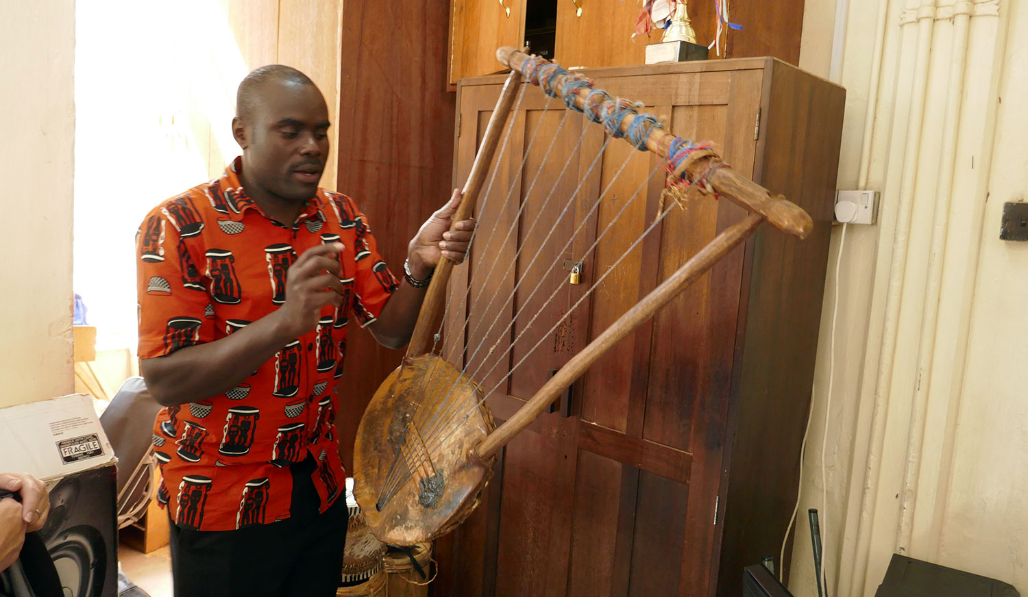 Leonard Wekesa, a choral conductor from Nairobi, Kenya, demonstrating a native Kenyan instrument.