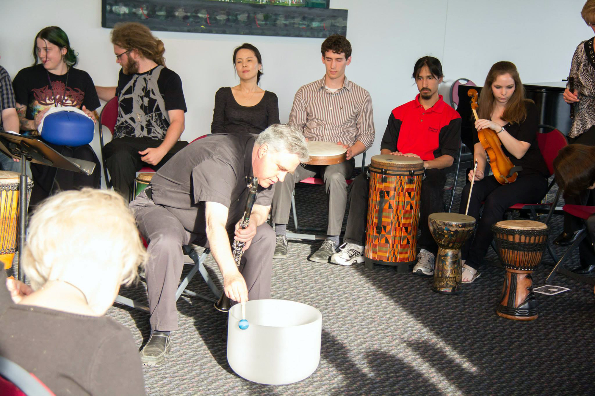 The Healing Arts Ensemble, lead by Dr. Glenn Smith at the center, gather for a relaxing music session.