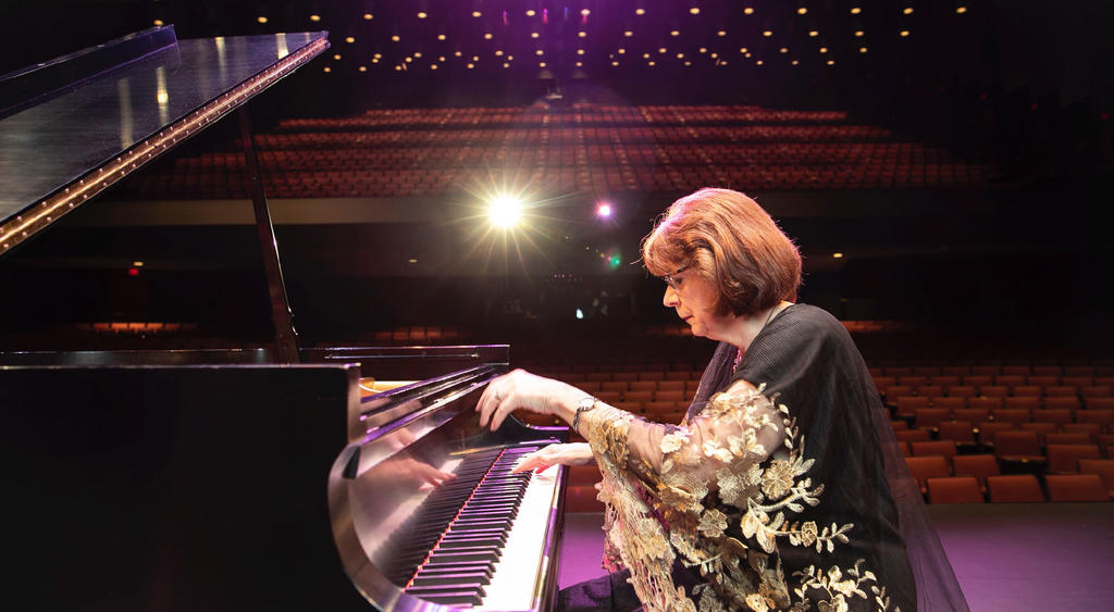 Director of the Dewberry School of music, Dr. Linda Monson, playing on the stage of the Center for the Arts