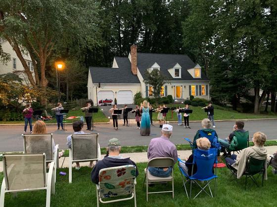 A group of musicians performs in the driveway of a suburban neighborhood in Northern Virginia, as part of a driveway concert organized by Julianna Nickel and her family. 
