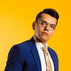 Prof. Benitez in blue suit against bright yellow background